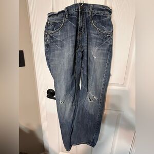 Buckle Manchester Jeans 34R with Holes in Both Knees and on the Back of One Leg.